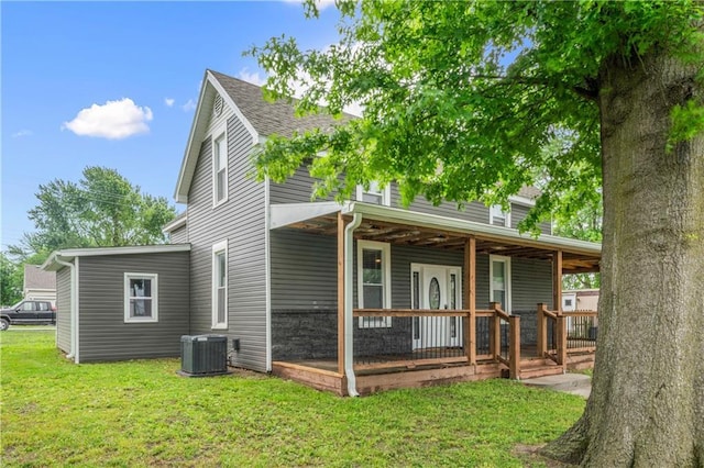 1105 S Gordon St, Concordia, MO 64020 - rear view of house with covered porch, central air condition unit, a lawn, and roof with shingles