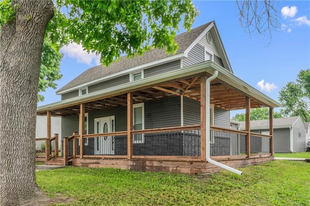 1105 S Gordon St, Concordia, MO 64020 - back of property featuring covered porch, a yard, and a shingled roof