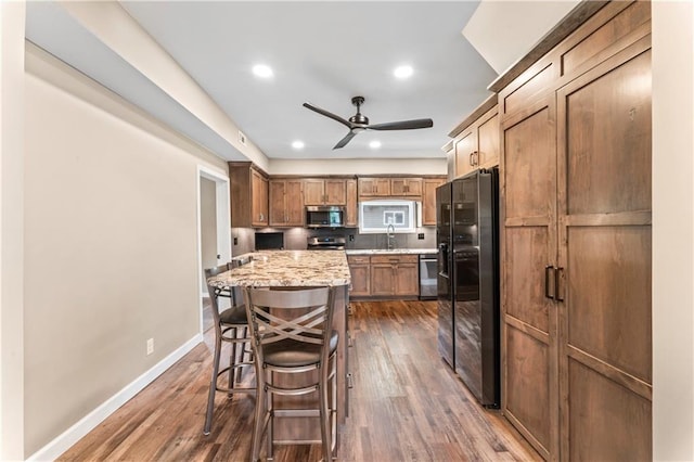 1105 S Gordon St, Concordia, MO 64020 - kitchen with appliances with stainless steel finishes, a sink, dark wood finished floors, a ceiling fan, and recessed lighting