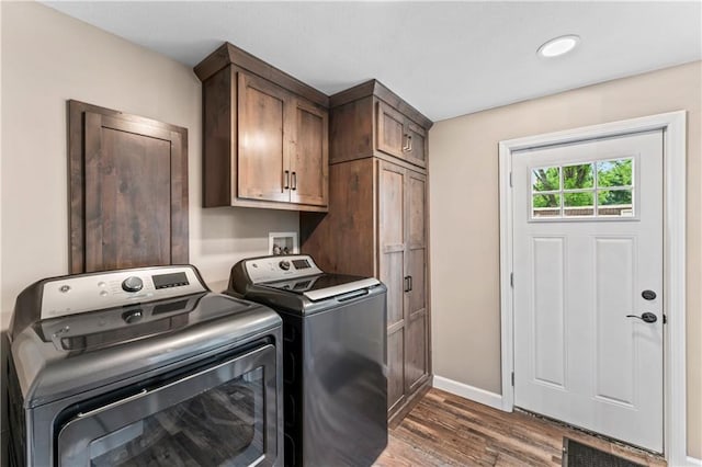 1105 S Gordon St, Concordia, MO 64020 - laundry area featuring independent washer and dryer, wood finished floors, cabinet space, and baseboards