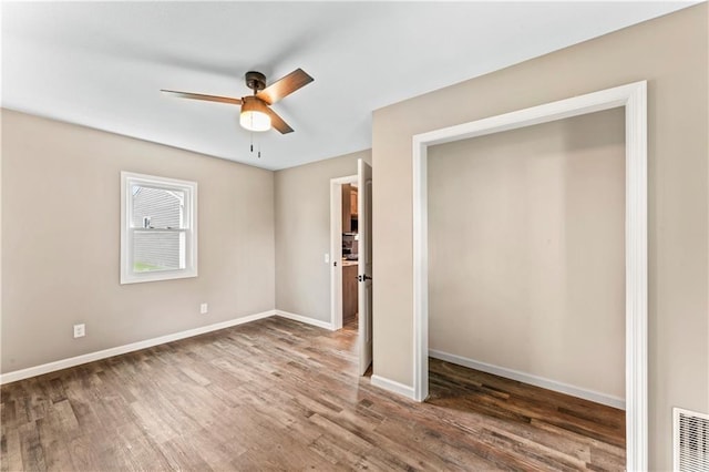 1105 S Gordon St, Concordia, MO 64020 - unfurnished bedroom featuring wood finished floors, baseboards, and a ceiling fan