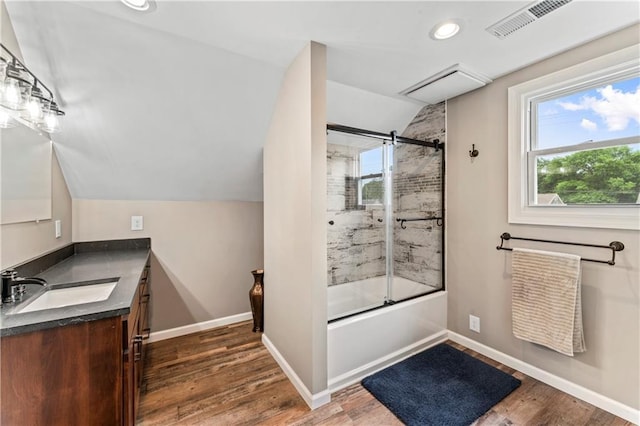 1105 S Gordon St, Concordia, MO 64020 - full bath with lofted ceiling, vanity, bath / shower combo with glass door, wood finished floors, and baseboards
