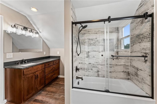 1105 S Gordon St, Concordia, MO 64020 - bathroom featuring shower / bath combination with glass door, wood finished floors, vaulted ceiling, vanity, and baseboards