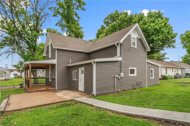 1105 S Gordon St, Concordia, MO 64020 - view of side of property with a lawn, a patio area, roof with shingles, and central AC unit