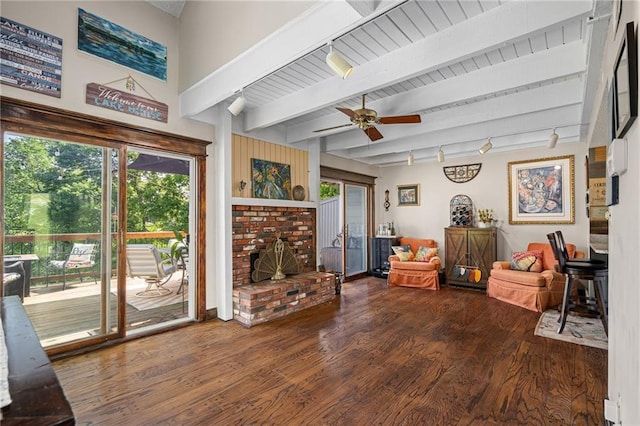 218 NE Bayview Dr, Lees Summit, MO 64064 - living room with wood finished floors, healthy amount of natural light, a ceiling fan, beamed ceiling, and rail lighting