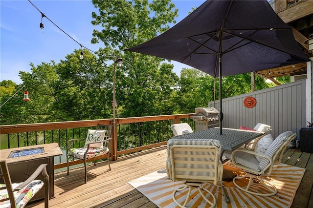 218 NE Bayview Dr, Lees Summit, MO 64064 - wooden terrace featuring a fire pit, grilling area, and outdoor dining space