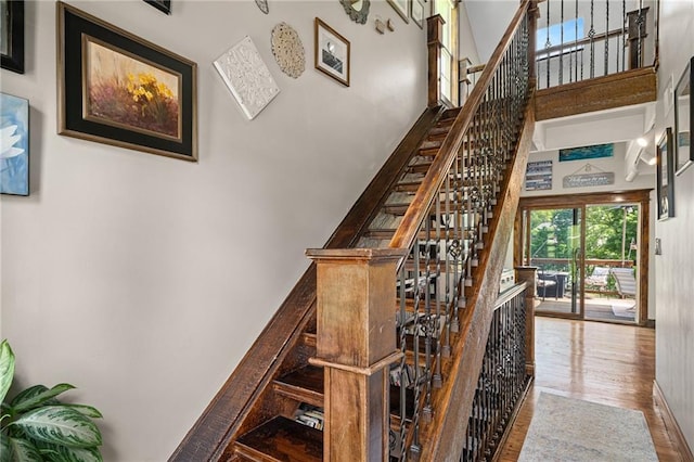218 NE Bayview Dr, Lees Summit, MO 64064 - stairway with a towering ceiling and wood finished floors