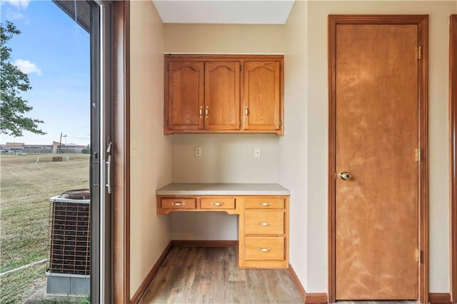 1109 Jeff Cir, Paola, KS 66071 - unfurnished office featuring built in study area, light wood-style flooring, and baseboards