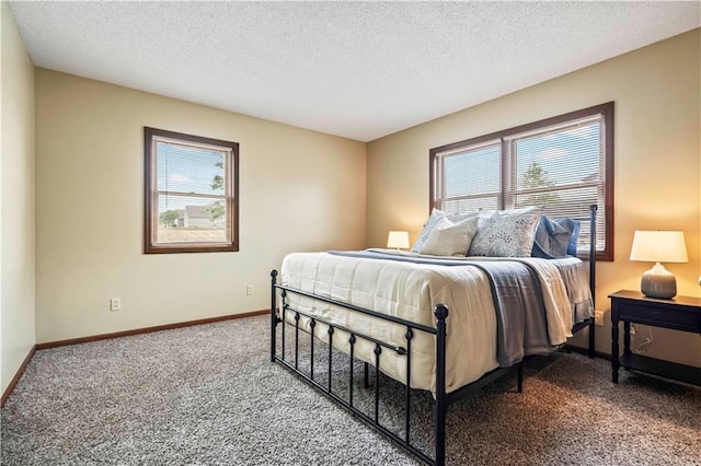1109 Jeff Cir, Paola, KS 66071 - bedroom featuring carpet flooring, multiple windows, baseboards, and a textured ceiling