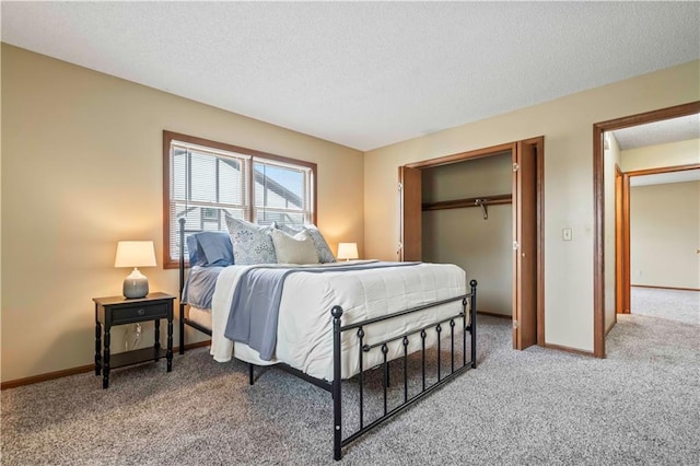 1109 Jeff Cir, Paola, KS 66071 - carpeted bedroom featuring a textured ceiling, a closet, and baseboards