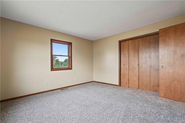 1109 Jeff Cir, Paola, KS 66071 - unfurnished bedroom with carpet floors, baseboards, and a closet