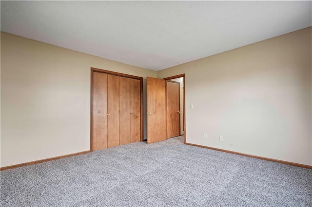 1109 Jeff Cir, Paola, KS 66071 - unfurnished bedroom featuring carpet flooring, baseboards, and a closet