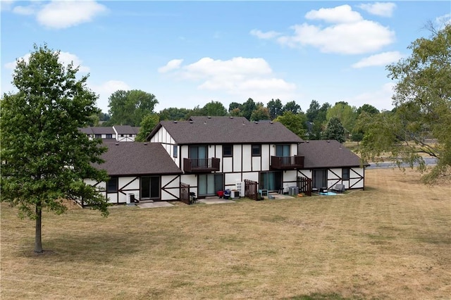 1109 Jeff Cir, Paola, KS 66071 - rear view of property featuring a lawn, a balcony, and roof with shingles