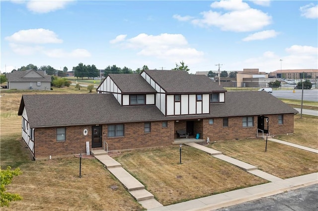 1109 Jeff Cir, Paola, KS 66071 - view of front of home with brick siding, a front lawn, roof with shingles, and a residential view