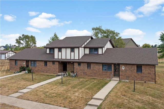 1109 Jeff Cir, Paola, KS 66071 - view of front of home featuring a front yard, brick siding, board and batten siding, and a shingled roof