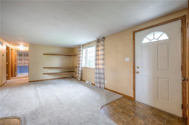 8713 Old Stagecoach Rd, Kansas City, MO 64154 - foyer entrance featuring baseboards and a textured ceiling