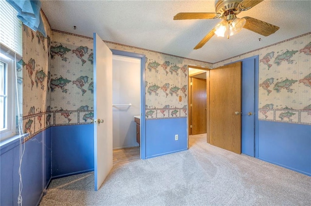 8713 Old Stagecoach Rd, Kansas City, MO 64154 - unfurnished bedroom with wallpapered walls, carpet flooring, a textured ceiling, multiple windows, and ceiling fan