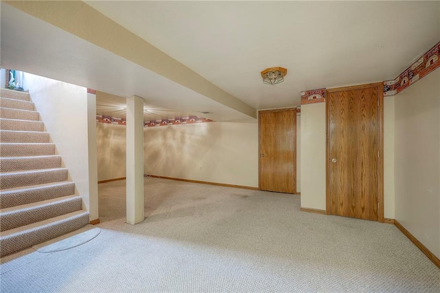 8713 Old Stagecoach Rd, Kansas City, MO 64154 - finished below grade area with carpet, baseboards, and stairs