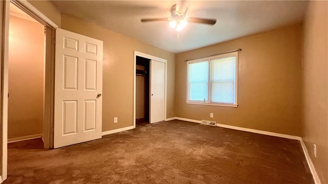1445 E 77th St, Kansas City, MO 64131 - unfurnished bedroom with dark carpet, a closet, and ceiling fan
