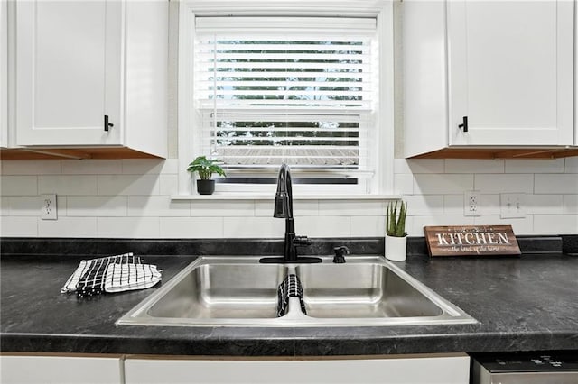 602 N College St, Richmond, MO 64085 - kitchen featuring white cabinetry, dark countertops, tasteful backsplash, and dishwasher