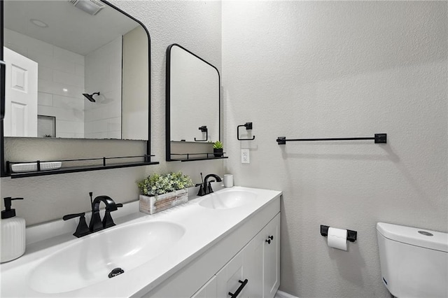 602 N College St, Richmond, MO 64085 - full bathroom with double vanity, a tile shower, and a textured wall