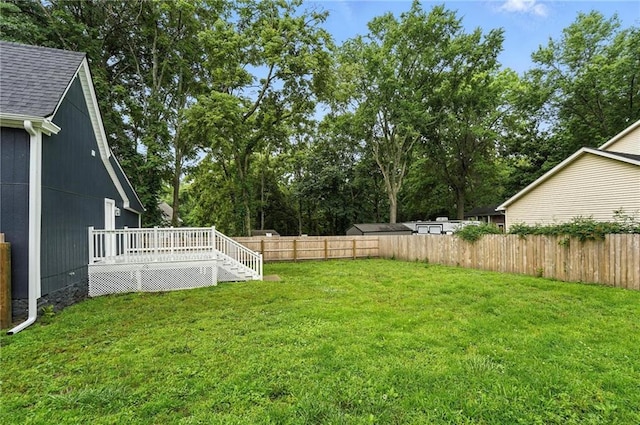 602 N College St, Richmond, MO 64085 - fenced backyard featuring a wooden deck and view of wooded area