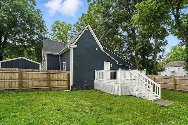 602 N College St, Richmond, MO 64085 - rear view of house featuring a deck, a fenced backyard, and roof with shingles