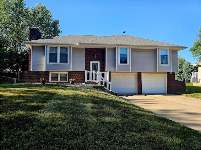 4513 Alpha Ln, Saint Joseph, MO 64506 - bi-level home with a chimney, an attached garage, brick siding, and concrete driveway