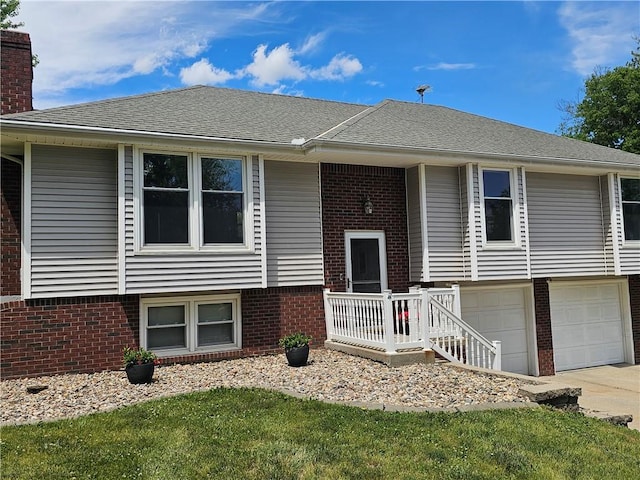 4513 Alpha Ln, Saint Joseph, MO 64506 - split foyer home with an attached garage, brick siding, a chimney, and driveway