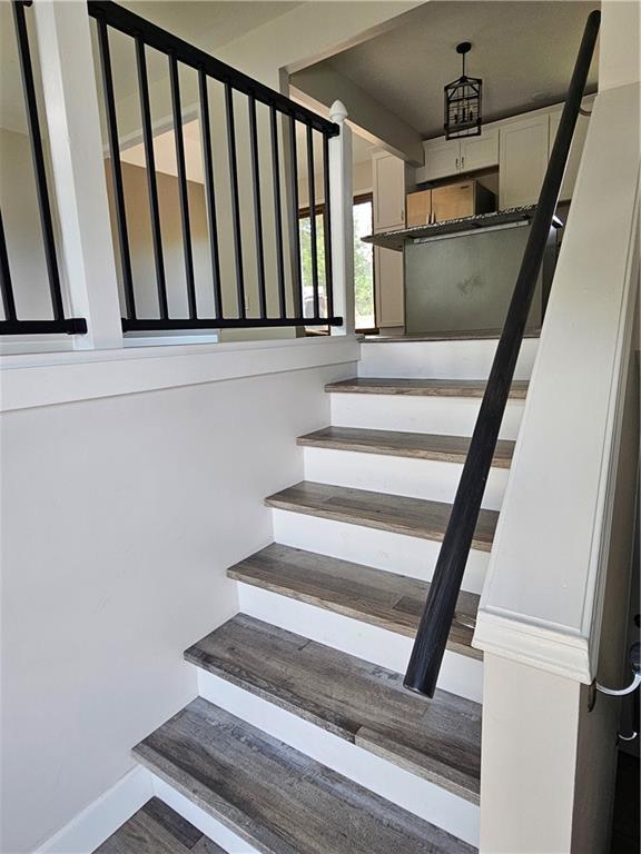 4513 Alpha Ln, Saint Joseph, MO 64506 - staircase featuring baseboards