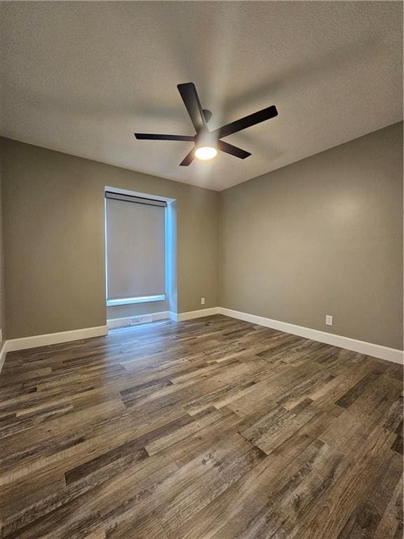 4513 Alpha Ln, Saint Joseph, MO 64506 - empty room with a ceiling fan, dark wood finished floors, baseboards, and a textured ceiling
