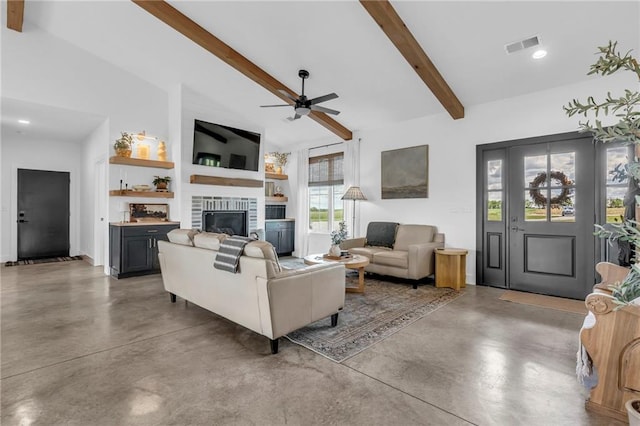 2363 Bainbridge Rd, Bates City, MO 64011 - living area featuring a ceiling fan, finished concrete flooring, a glass covered fireplace, recessed lighting, and built in features