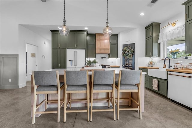 2363 Bainbridge Rd, Bates City, MO 64011 - kitchen featuring green cabinetry, white appliances, tasteful backsplash, concrete floors, and light countertops