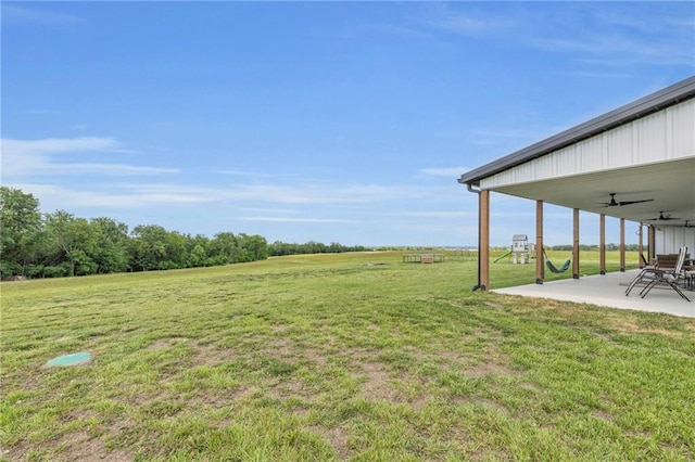 2363 Bainbridge Rd, Bates City, MO 64011 - view of grassy yard featuring ceiling fan and a patio