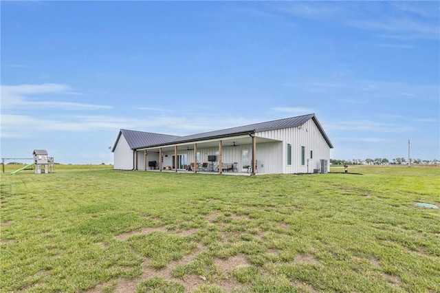 2363 Bainbridge Rd, Bates City, MO 64011 - rear view of house featuring a lawn, metal roof, and board and batten siding