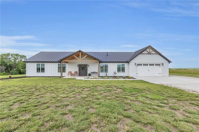 2363 Bainbridge Rd, Bates City, MO 64011 - modern farmhouse style home with board and batten siding, driveway, a garage, and a front lawn