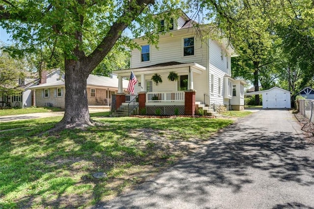 1795 S Norwood Ave, Independence, MO 64052 - american foursquare style home featuring covered porch, an outbuilding, driveway, and a garage