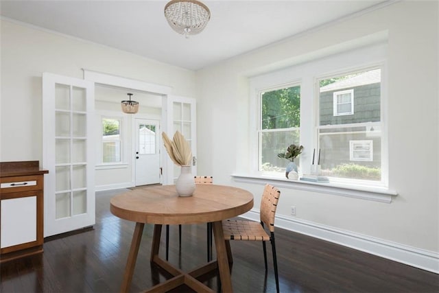 1795 S Norwood Ave, Independence, MO 64052 - dining area with a chandelier, dark wood-style floors, plenty of natural light, baseboards, and ornamental molding