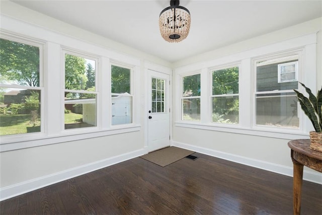 1795 S Norwood Ave, Independence, MO 64052 - unfurnished sunroom featuring healthy amount of natural light and a chandelier
