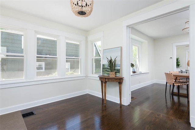 1795 S Norwood Ave, Independence, MO 64052 - dining space featuring a chandelier, dark wood-style flooring, and baseboards