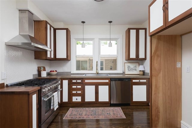 1795 S Norwood Ave, Independence, MO 64052 - kitchen with stainless steel appliances, wall chimney range hood, a sink, dark wood finished floors, and decorative backsplash