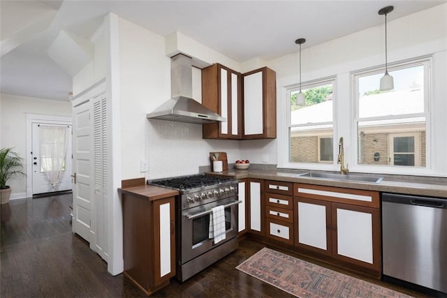 1795 S Norwood Ave, Independence, MO 64052 - kitchen with appliances with stainless steel finishes, wall chimney range hood, a sink, dark wood-type flooring, and backsplash