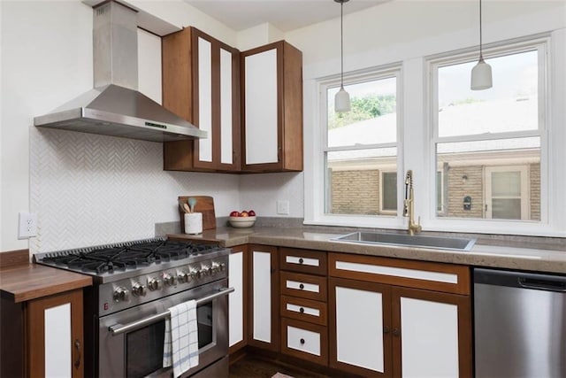 1795 S Norwood Ave, Independence, MO 64052 - kitchen featuring stainless steel appliances, wall chimney exhaust hood, a sink, and dark countertops
