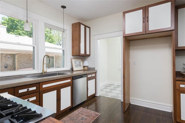 1795 S Norwood Ave, Independence, MO 64052 - kitchen featuring dishwasher, a sink, dark flooring, decorative light fixtures, and baseboards