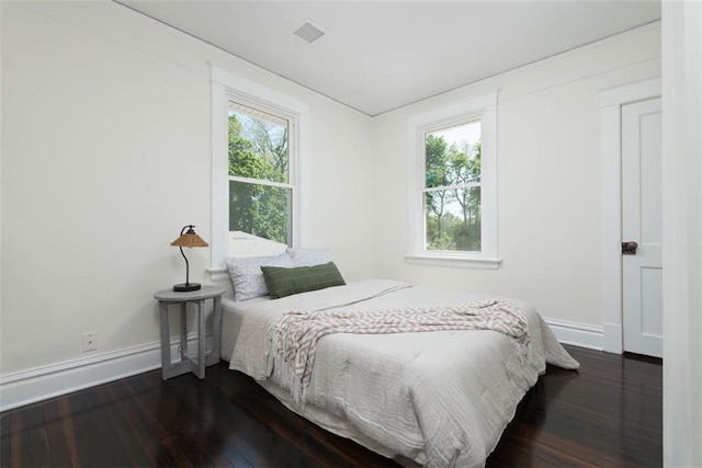 1795 S Norwood Ave, Independence, MO 64052 - bedroom featuring baseboards, multiple windows, and dark wood-type flooring