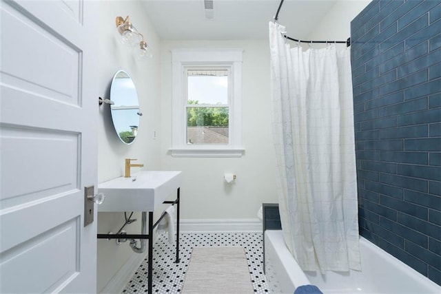 1795 S Norwood Ave, Independence, MO 64052 - full bathroom with baseboards, shower / bathtub combination with curtain, and tile patterned floors