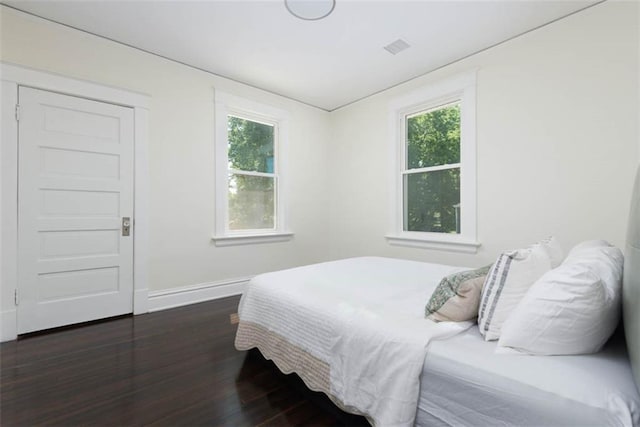 1795 S Norwood Ave, Independence, MO 64052 - bedroom featuring dark wood-type flooring, baseboards, and multiple windows
