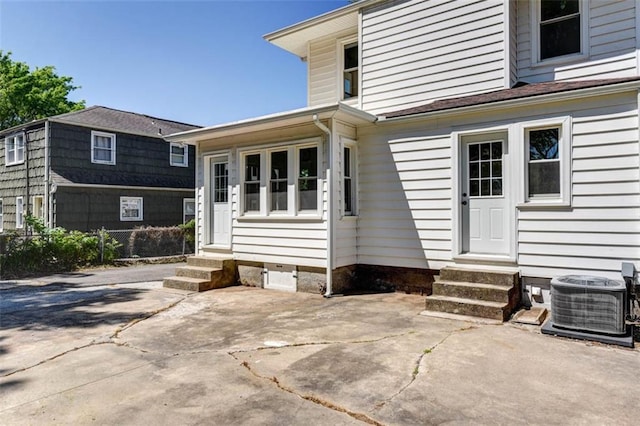 1795 S Norwood Ave, Independence, MO 64052 - entrance to property featuring cooling unit and a patio area