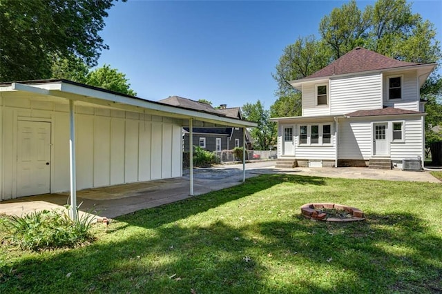 1795 S Norwood Ave, Independence, MO 64052 - back of property with entry steps, a yard, a patio area, and roof with shingles