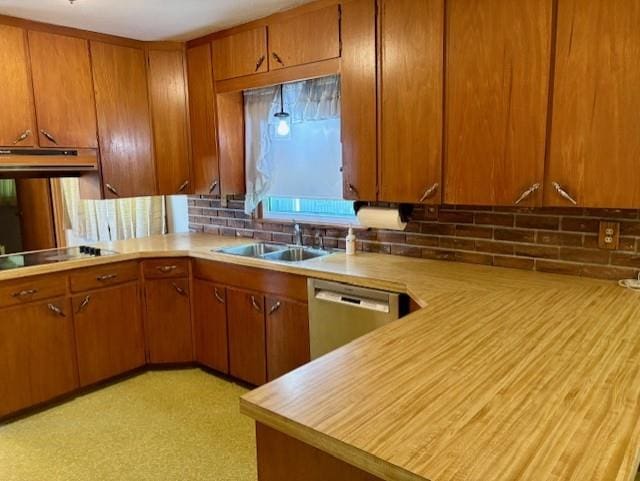 22025 Ness Rd, Parsons, KS 67357 - kitchen with stainless steel dishwasher, a sink, light countertops, under cabinet range hood, and brown cabinets